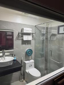 a bathroom with a shower and a toilet and a sink at Hoàng Gia Long Biên Hotel in Hanoi +6 photos