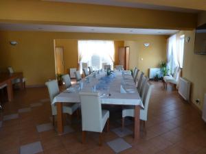 a large dining room with a long table and chairs at Penzión Koruna in Nitrianske Rudno