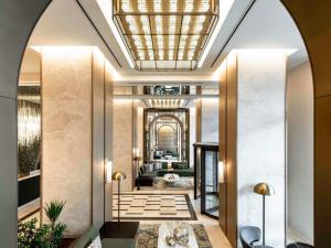 a lobby of a hotel with a ceiling at Mövenpick Istanbul Old Town in Istanbul