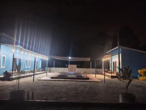 a building with a fountain at night with lights at D'Biru Guest Room in Melur