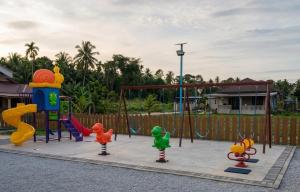 a playground with colorful play equipment in a yard at D'Biru Guest Room in Melur