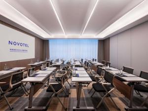 a large room with tables and chairs and a whiteboard at Novotel Changshu Yushan in Changshu +76 photos