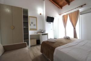 a bedroom with a bed and a desk and a window at Hotel Beach Restaurant Fabio in Borsh +260 photos