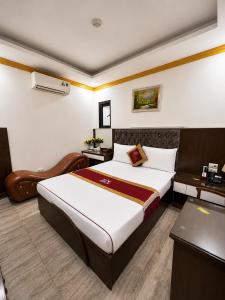 a hotel room with a bed and a desk at Hoàng Gia Long Biên Hotel in Hanoi