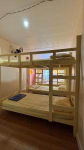 a group of bunk beds in a room at Buku island in san juan la union