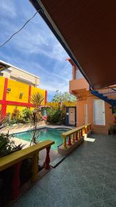 a swimming pool in a building with two benches at Buku island in san juan la union