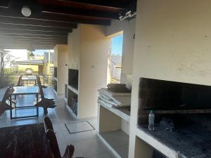 a kitchen with a fireplace and a table and chairs at Complejo Anjana in Federación