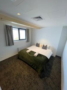 a bedroom with a large bed in a room at Carruthers Chalet in Perisher Valley