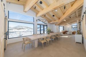 a large dining room with a table and chairs at Carruthers Chalet in Perisher Valley