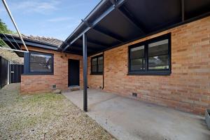 a brick building with a solarium on the side of it at The Ironbark Nest in Bendigo