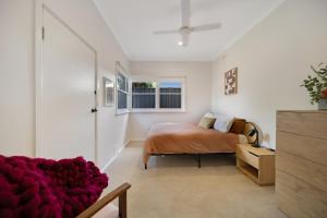 a bedroom with a bed and a couch at The Ironbark Nest in Bendigo
