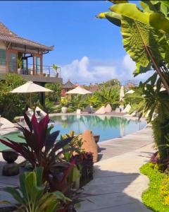 a pool at the resort with a view of the ocean at Spaces Bali Unique Boutique Hotel in Canggu