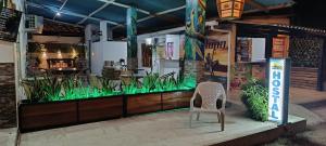 a restaurant with a chair in front of it at WARI RUNA HOSTAl 103 in Necoclí