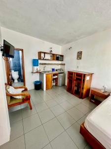 a room with a bed and a room with a kitchen at SUITE5 ROMANTICA TERRAZA Y VISTa in Huamboya +15 photos