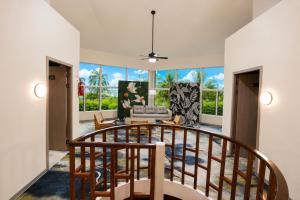 a living room with a spiral staircase and a living room at Rainbow Holiday Resort in Nadi