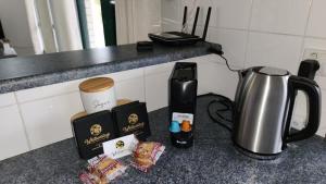 a kitchen counter with a coffee maker and a kettle at The Goose Ponds in North Mackay +9 photos