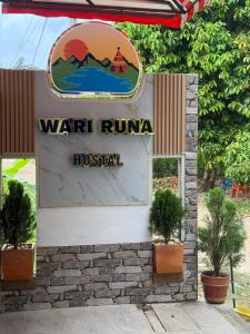 a sign for a walt runa hospital at WARI RUNA HOSTAl 103 in Necoclí