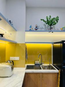 a kitchen with a sink and a refrigerator and a sink at KB Villas 51 in Bình Tú +30 photos