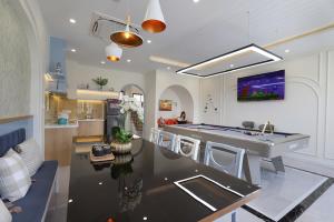 a kitchen and living room with a pool table at KB Villas 51 in Bình Tú