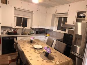 a kitchen with a table with flowers on it at Oshawa Duplex in Oshawa