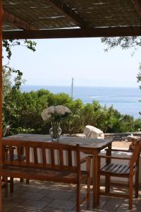 a table with a vase of flowers on top of a table at Nereidi Villas in Porto Ozias +18 photos