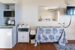 a kitchen with a table and a refrigerator at The Sunset Sea in Eimeo