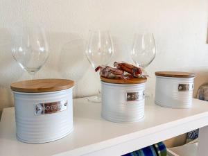 three wine glasses sitting on a shelf with food in them at The Sunset Sea in Eimeo