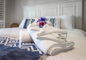 a pile of towels sitting on top of a bed at The Sunset Sea in Eimeo
