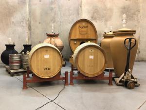 a group of wine barrels on display in a room at Truffle Ridge Vineyard Stay in Martinborough
