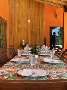 a long table with plates and glasses on it at Branca Countryside Retreat in Coruche