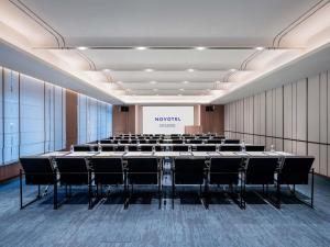 a conference room with a large table and chairs at Novotel Hangzhou Binjiang in Hangzhou