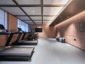 a gym with treadmills and machines in a room at Novotel Hangzhou Binjiang in Hangzhou