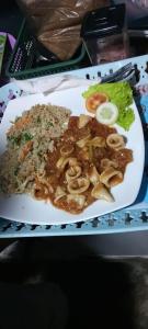 a plate of food with mushrooms and rice on a table at Happy Hippy Beach Cabanas Peanut Farm in Panama +63 photos