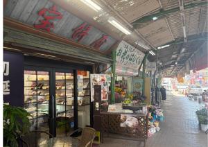 a market with a flower shop on a street at ステイインアット勝富 in Sasebo
