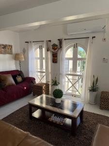 a living room with a couch and a coffee table at One more night in Ocho Rios +32 photos