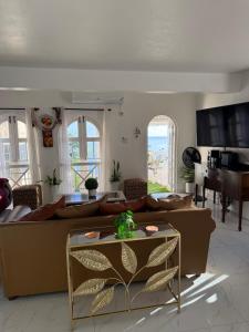 a living room with a couch and a table at One more night in Ocho Rios