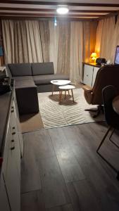 a living room with a couch and a table at Chalet Lieke Nr386 in Eext