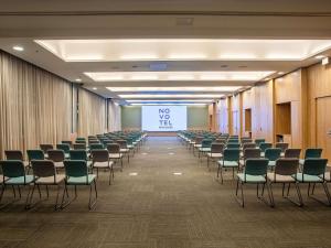 a room with chairs and a screen with a presentation at Novotel Sao Paulo Morumbi in São Paulo