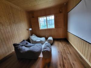 an empty room with two couches and a window at Haepung Stay in Yŏnamp'o