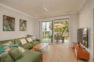 a living room with a couch and a table at House Olive Tree in Bijela