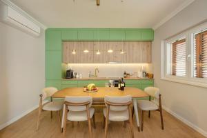 a kitchen with a wooden table and chairs in a room at House Olive Tree in Bijela +35 photos