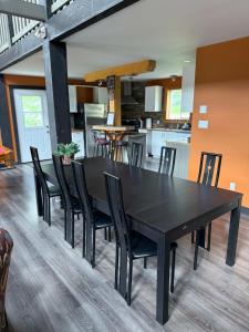 a black dining room table and chairs in a kitchen at GROWL Lodge - Hot Tub & Mountain Views! in Golden