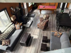 an overhead view of a living room with a pool table at GROWL Lodge - Hot Tub & Mountain Views! in Golden +46 photos
