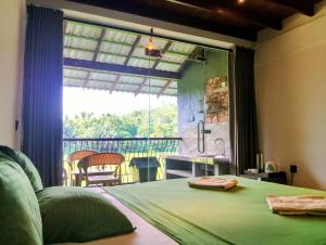 a bedroom with a bed and a large window at Leisure Land in Galle
