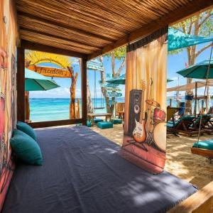 a room with a bed with a listening device on the beach at Freedom Beach Club in Barú