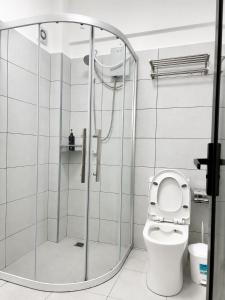 a bathroom with a shower with a toilet at Alina Ridge in Nairobi
