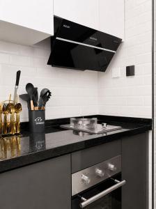 a kitchen with a black and white counter top at Alina Ridge in Nairobi +1 photo