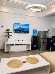 a living room with a tv on a wall at Alina Ridge in Nairobi