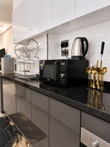 a kitchen with a black microwave on a counter at Alina Ridge in Nairobi