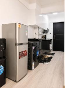 a kitchen with a stainless steel refrigerator and appliances at Alina Ridge in Nairobi